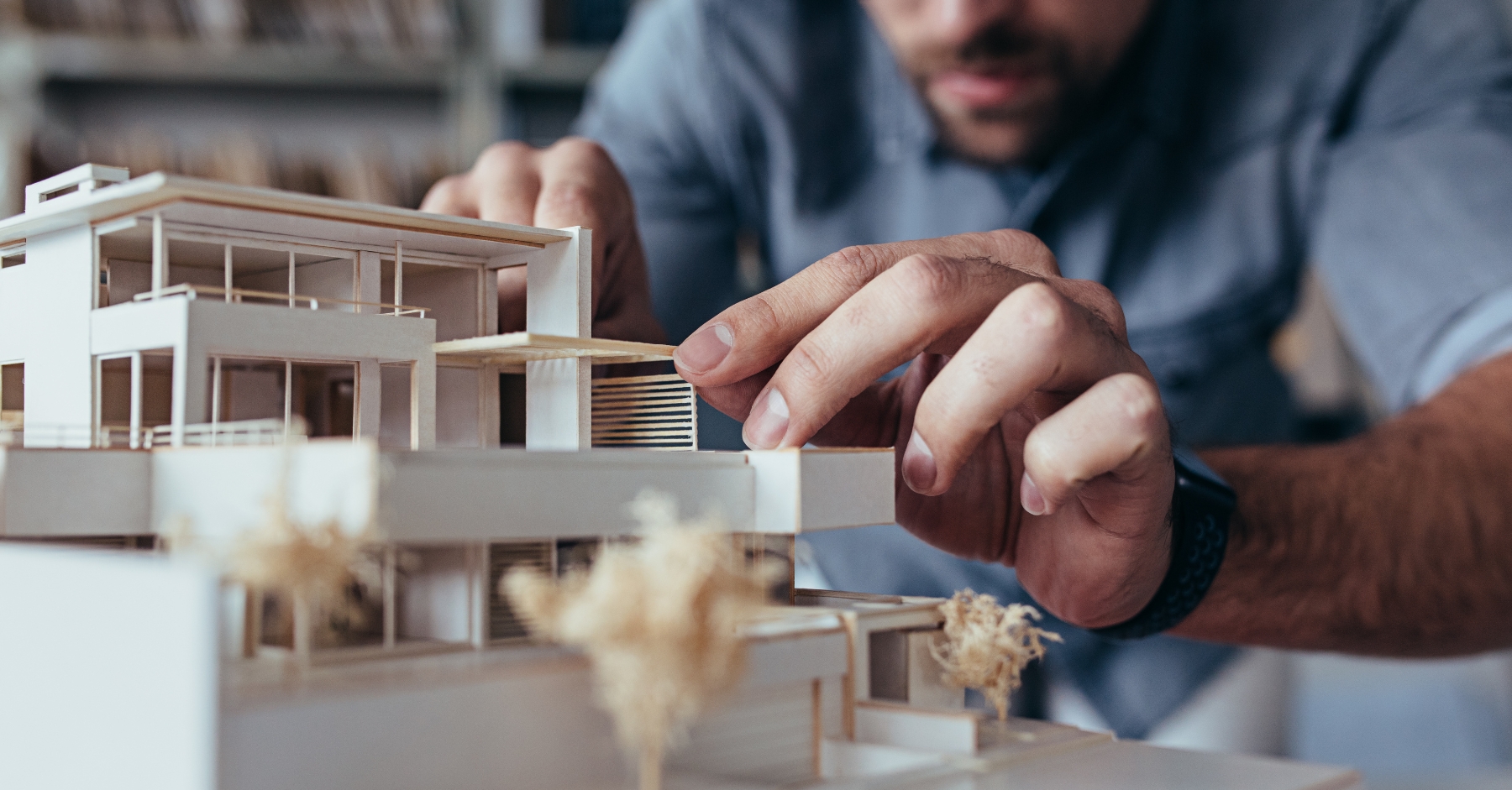 An architect uses 3D printing construction tools to make a model of a project