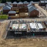 Construction industry growth New housing development under construction in the UK with brick houses, scaffolding and roads forming a growing estate