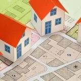 A stylised image of model buildings on a planned layout