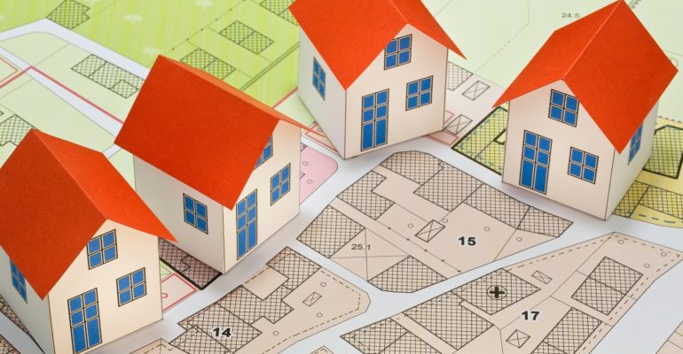 A stylised image of model buildings on a planned layout