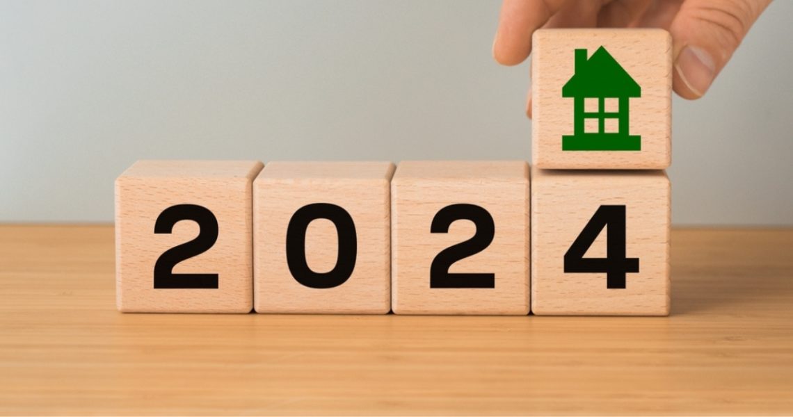 wooden blocks depicting the number 2024 with a green house above them