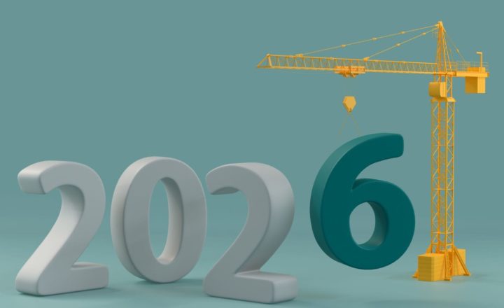 How the Autumn Budget Affects Construction Hiring: A 3D render of the year 2026 in large white numbers, with a yellow tower crane lowering a dark teal number 6 into place against a soft teal background.