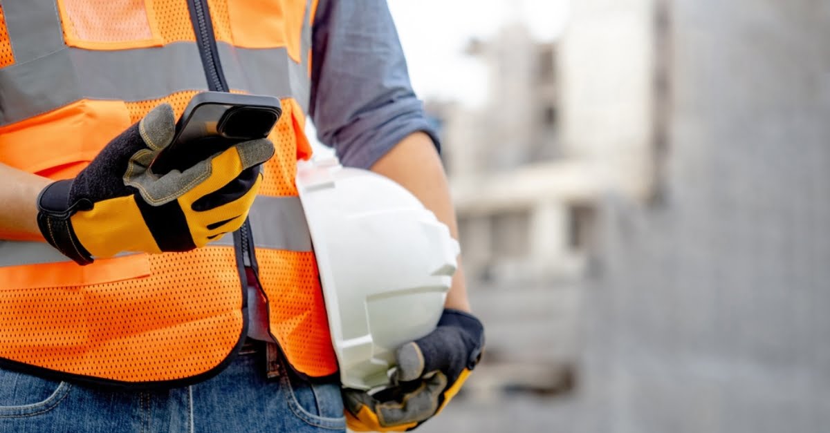 A construction worker on their phone accessing role support