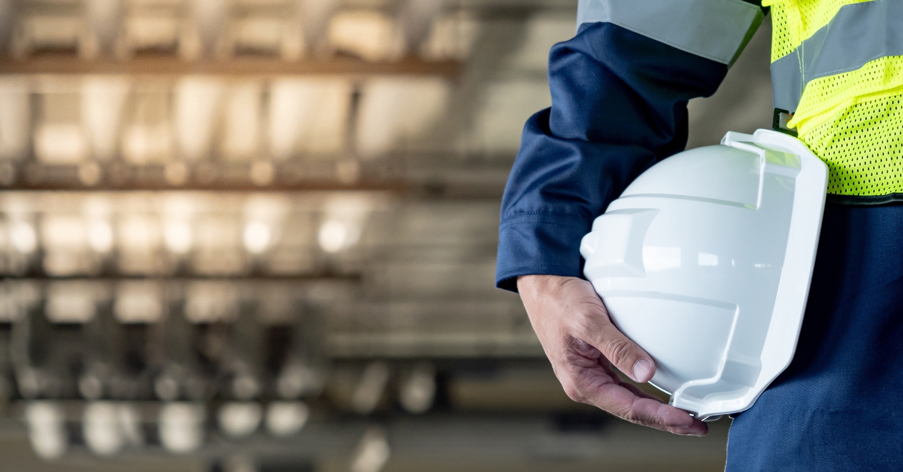 A construction training person holding a white helmet